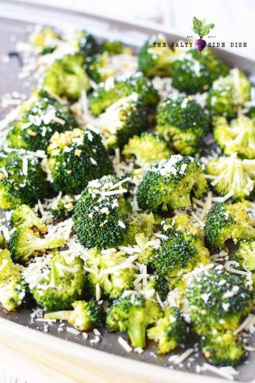 roasted broccoli with parmesan cheese on baking sheet