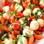 bowl of cherry tomatoes, mozzarella and basil to make caprese salad.