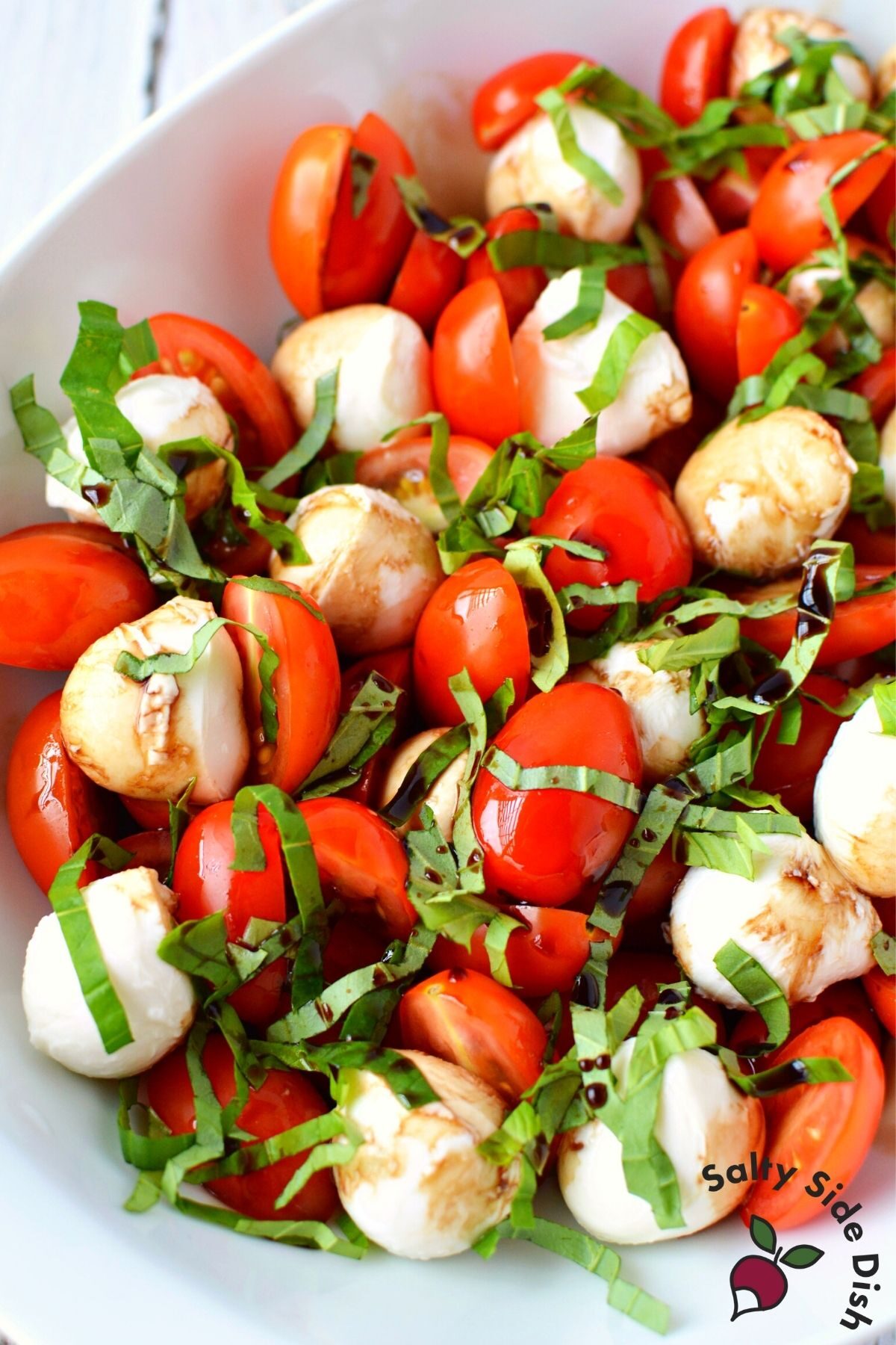 cherry tomato caprese salad in a bowl.