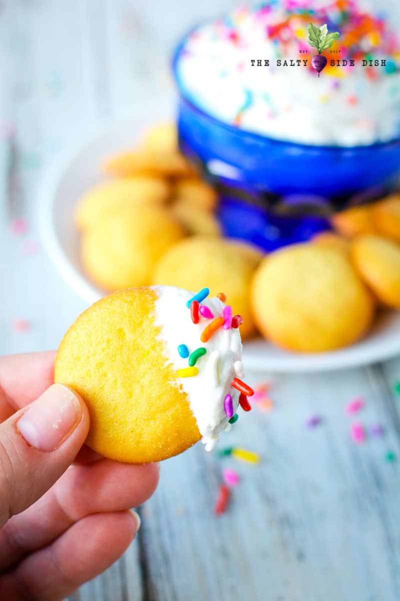 Funfetti Dip Recipe | Funfetti Cake Dip is a super fun, super delicious cake batter dessert dip waiting to be dunked with graham crackers or Nilla Wafers. Layers on the sprinkles and let's get Dipping! #dip #dessertdip #dessert #appetizer #party #parties #dips funfetti dip recipe like old fashioned dunkaroo dip ready for a cookie
