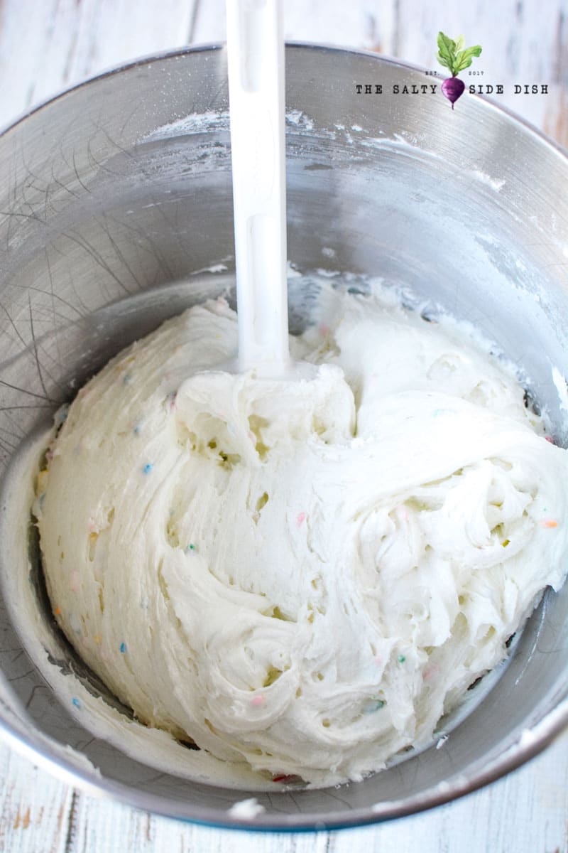 Funfetti Dip Recipe | Funfetti Cake Dip is a super fun, super delicious cake batter dessert dip waiting to be dunked with graham crackers or Nilla Wafers. Layers on the sprinkles and let's get Dipping! #dip #dessertdip #dessert #appetizer #party #parties #dips funfetti cake dip fluffy and sweet in a bowl is a perfect cake batter dip that can be customized easily
