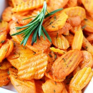 oven roasted carrots with rosemary in a white bowl