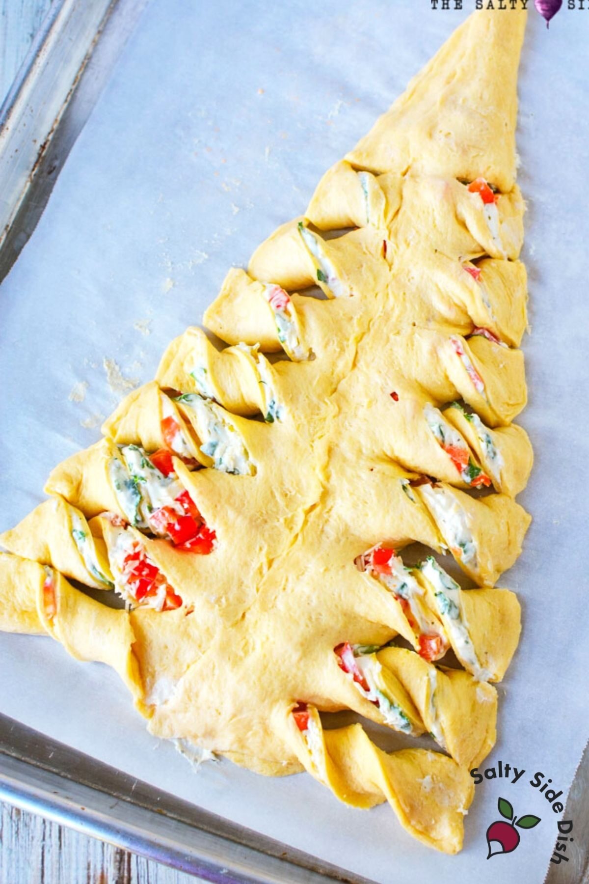 christmas tree twist bread laying on a baking sheet with parchment paper. 