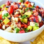 white bowl with strawberry caprese salad and tortillas.
