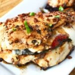 white plate with Caprese stuffed chicken.