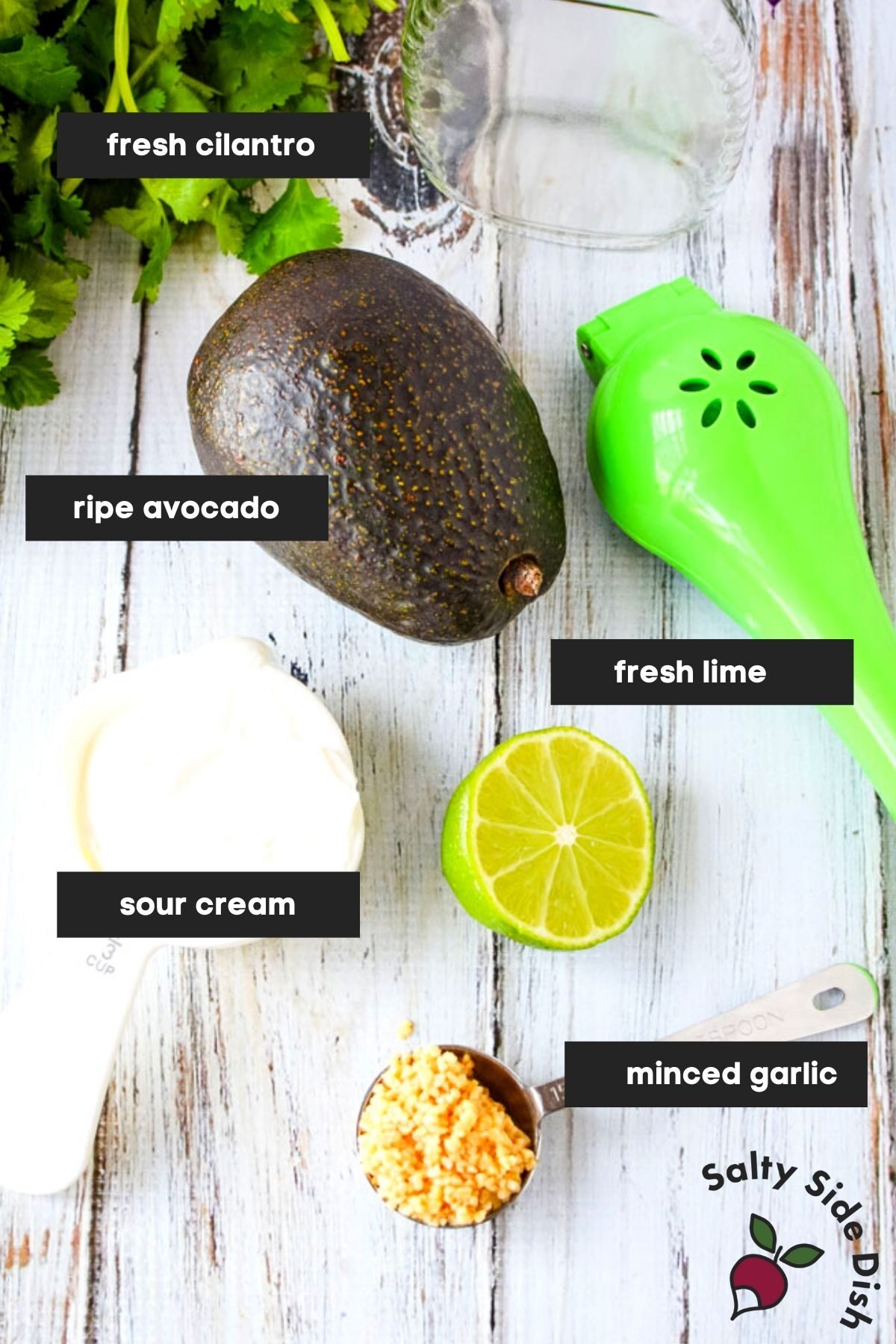 homemade avocado salad dressing ingredients on a table and labeled.