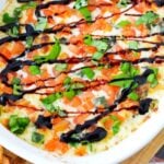 easy cheesy dip in a stoneware casserole dish and melba toast on the side