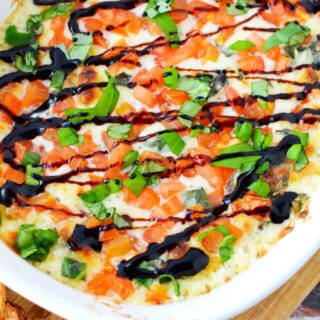 easy cheesy dip in a stoneware casserole dish and melba toast on the side