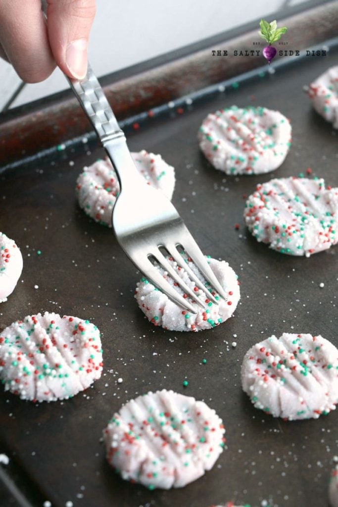 flatten mints with a fork on a baking pan