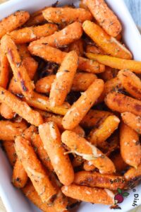 close up of parmesan roasted baby carrots showing crispy texture and melted cheese