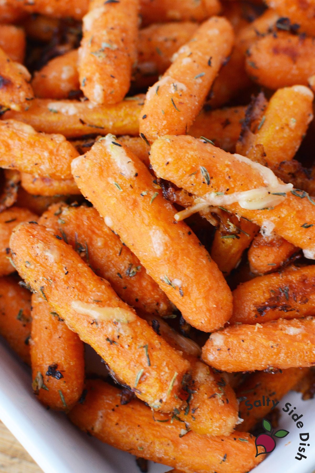 parmesan roasted baby carrots served warm in a white dish