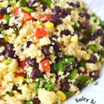 large bowl of couscous salad with a serving spoon.