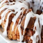 cinnamon roll monkey bread with caramel sauce and white icing.