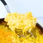 scooping casserole in a spoon.