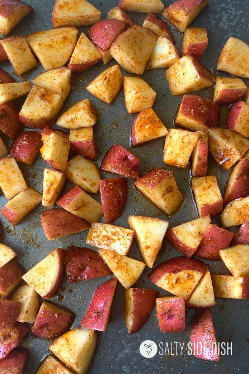 potatoes dumped on baking pan and ready for the oven