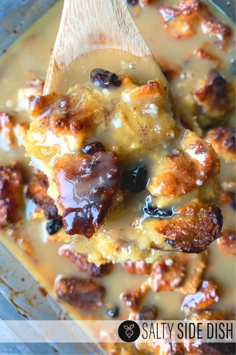 Apple Cinnamon Bread Pudding with Caramel Custard Glaze sauce on a wooden spoon