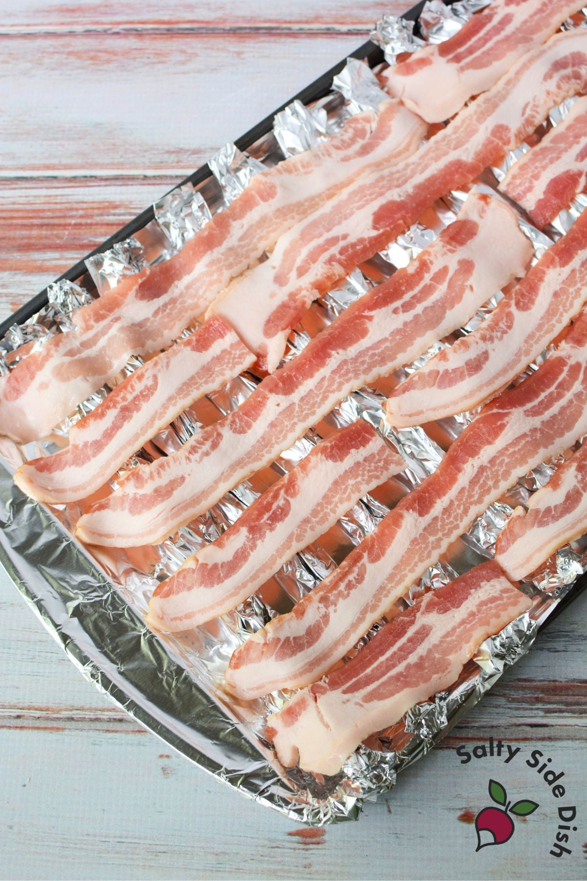 DIY foil bacon rack setup on baking sheet for crispier oven-cooked bacon