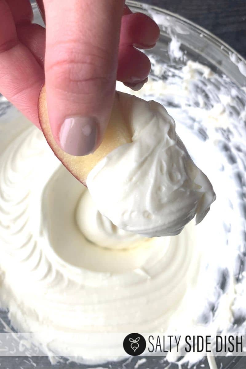 dipping apple in homemade fruit dip