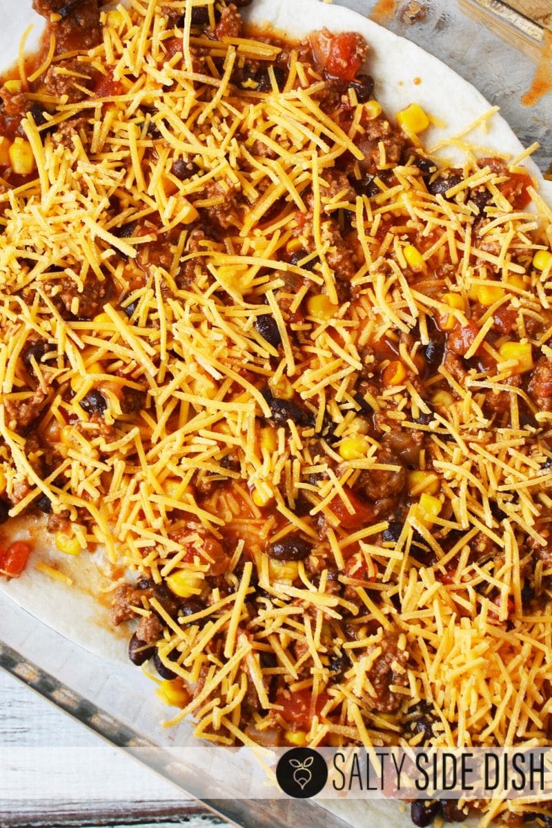 adding cheese to top layer of mexico casserole bake