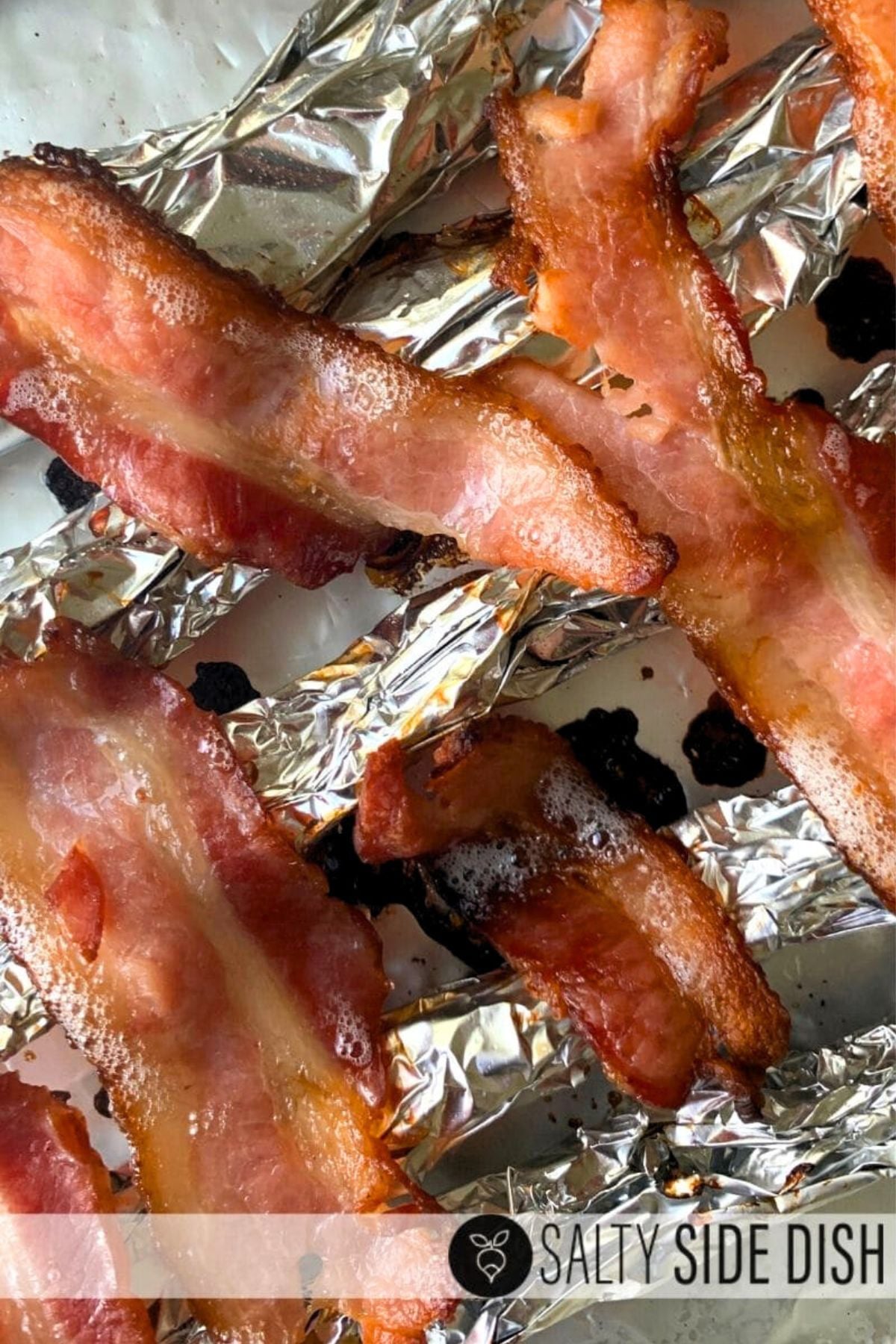Close-up of raw bacon on homemade foil rack for oven-baked bacon