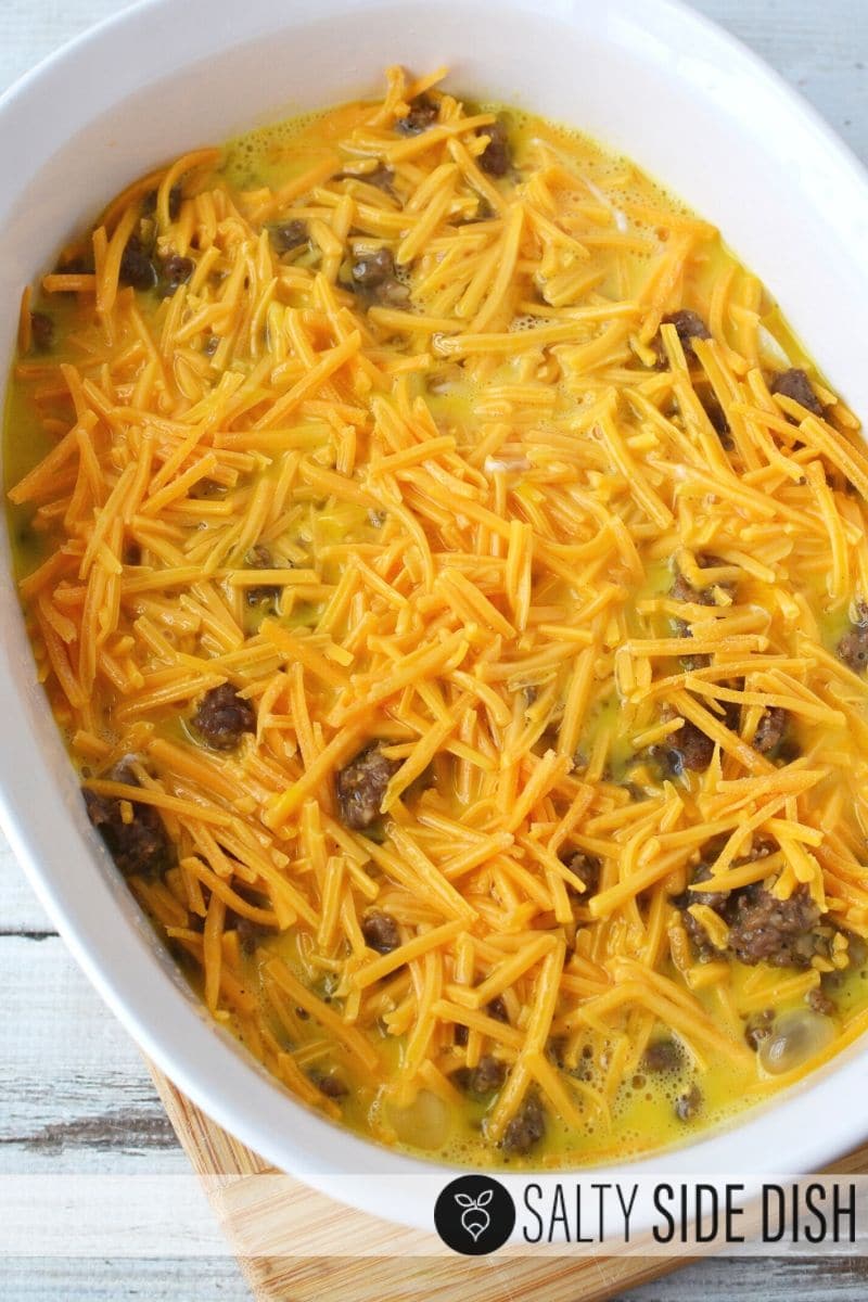 Layer biscuits, breakfast sausage, eggs and cheese into a casserole dish