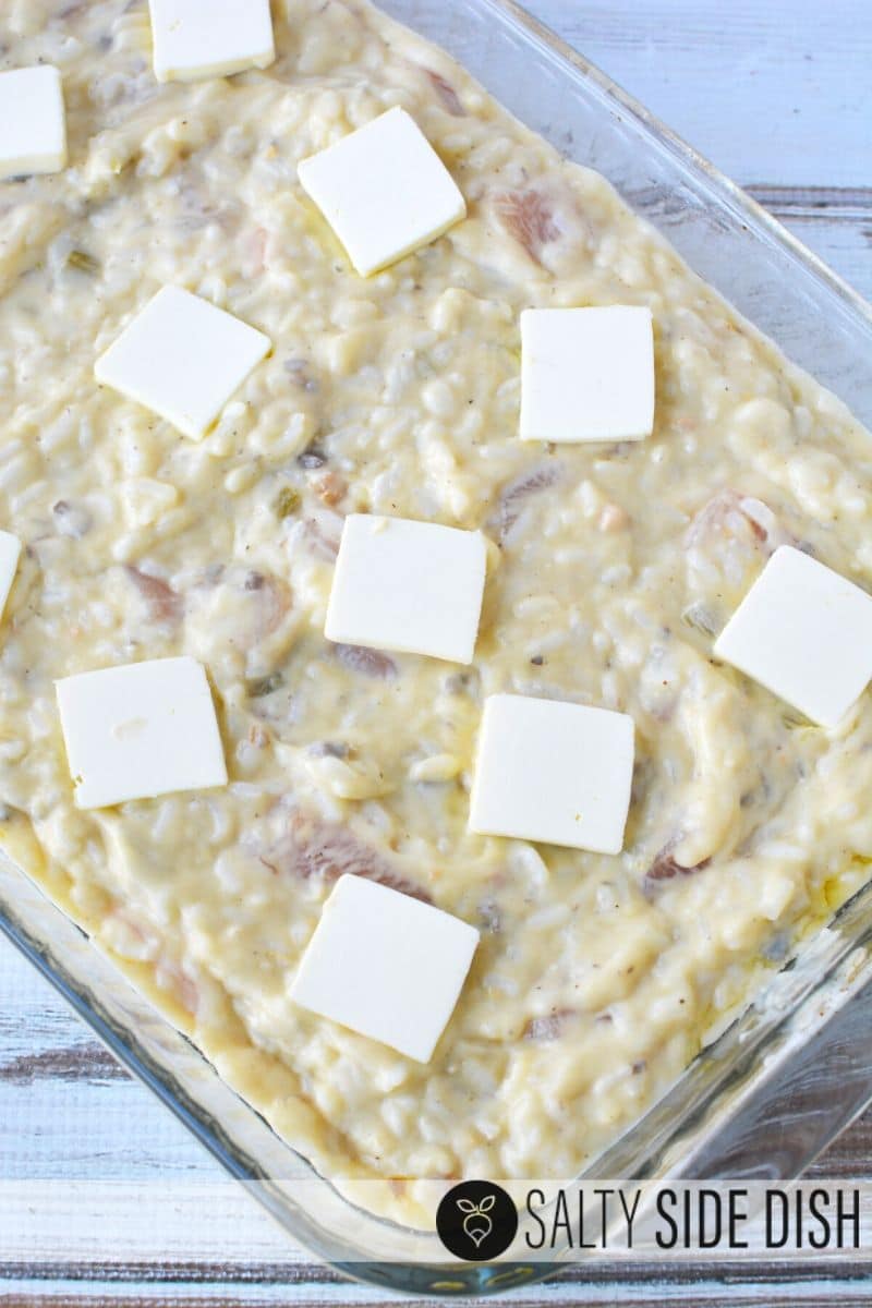 Easy Chicken and Rice Bake with Cream of Condensed Soups, a savory filling dinner with Pantry ingredients pats of butter simple casserole dish ready to be cooked