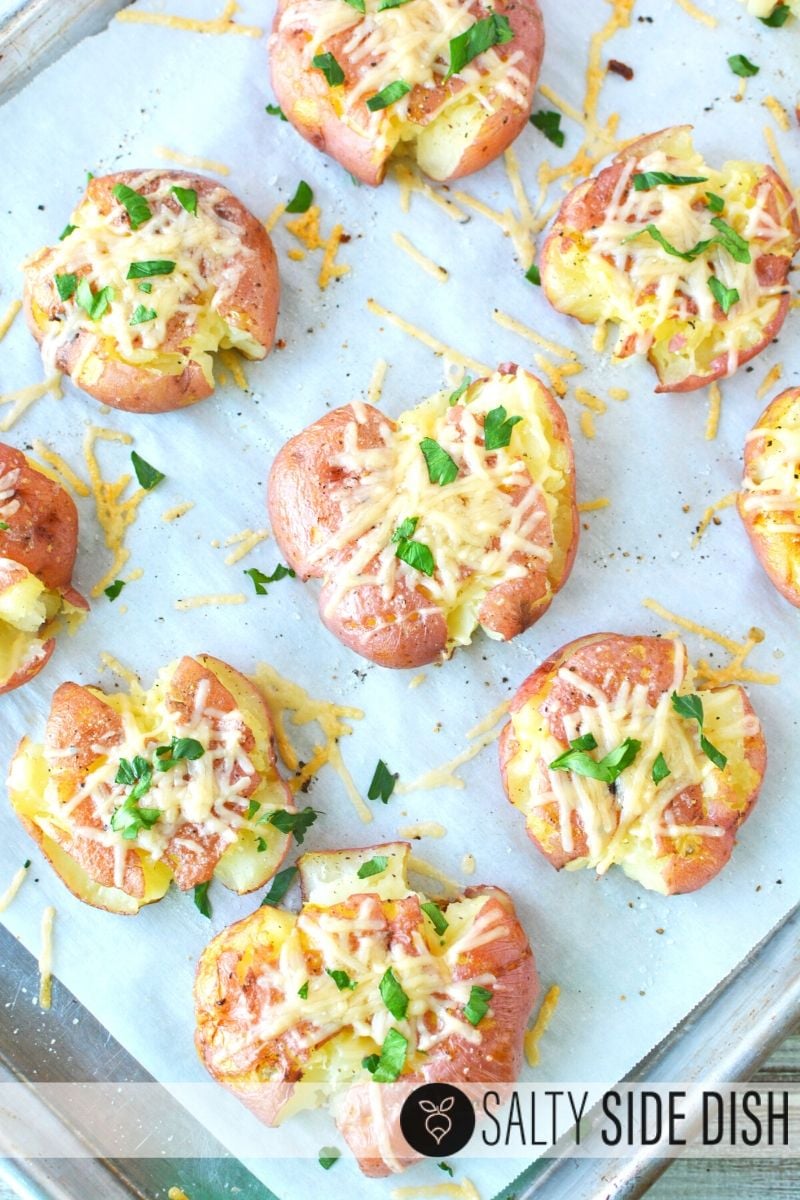 Smashed Red Potatoes ready to eat with melted shredded Parmesan and herbs on top