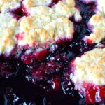 Blackberry cobbler in a cast iron pan.