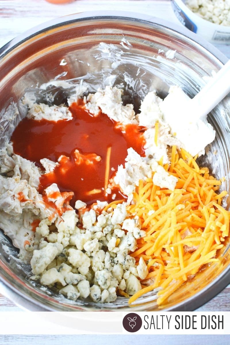 Blue Cheese, cheddar, hot sauce and cream cheese in a bowl