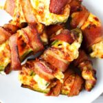 stuffed jalapenos with bacon on a white plate