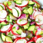 piles of radish and cucumbers in a bowl.