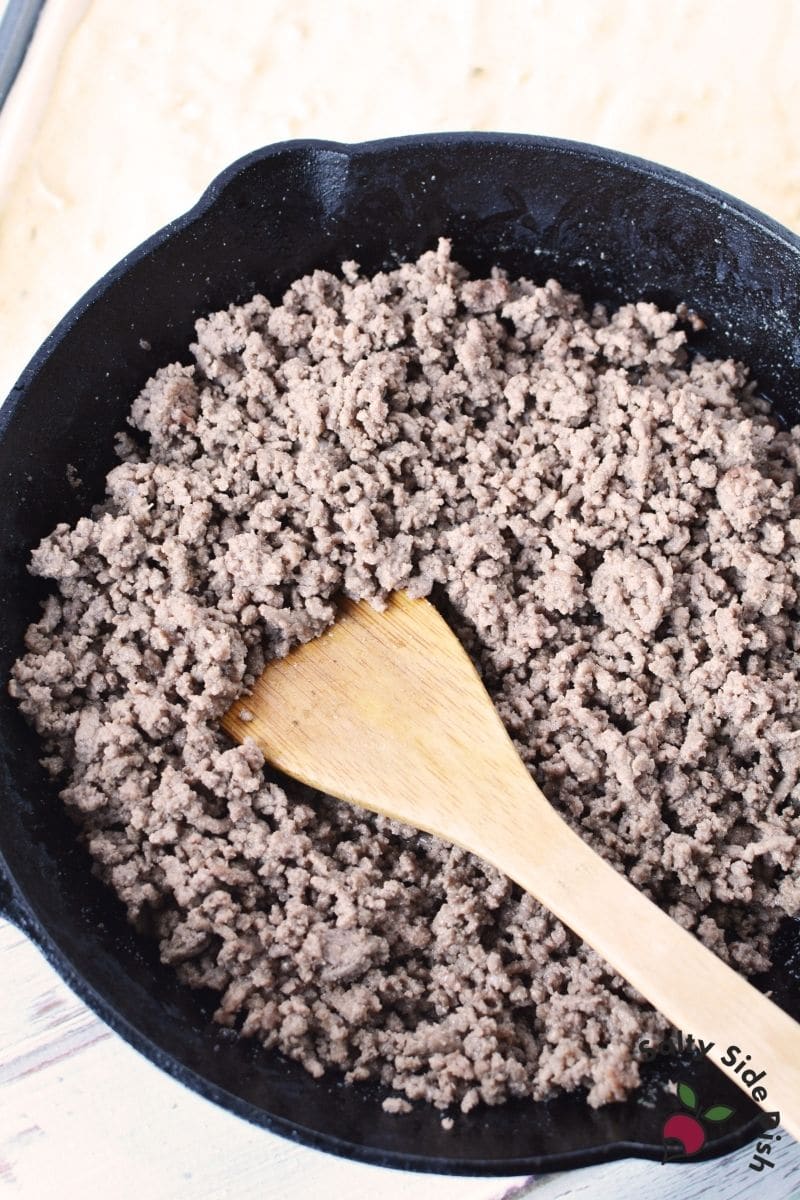 seasoned ground beef in a cast iron skillet