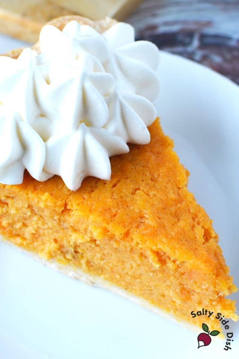 Southern Sweet Potato Pie recipe, the best and easiest sweet potato pie recipe for Thanksgiving and Christmas dessert menus Southern sweet potato pie, sliced, with a dollop of whipped cream on top ready to serve