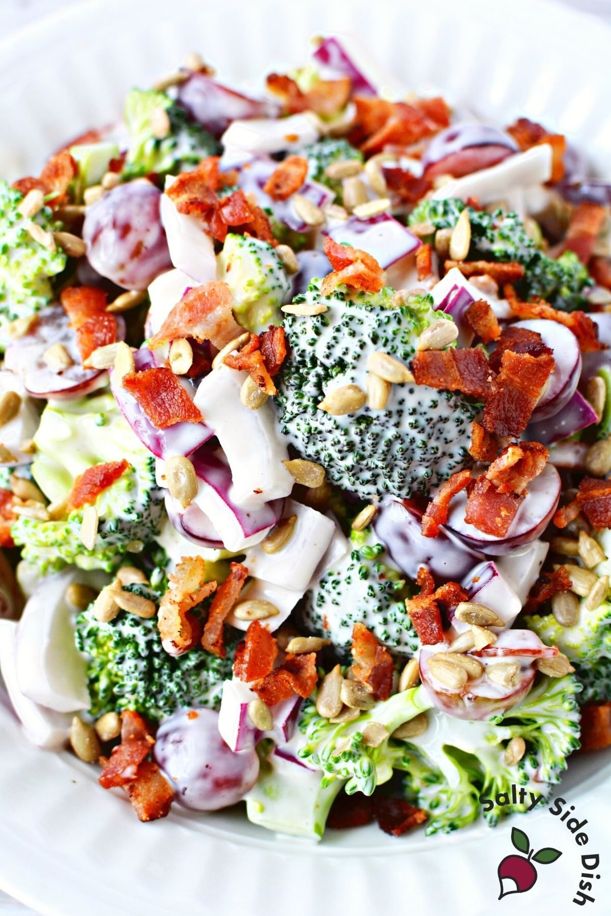 broccoli and grape salad in a white bowl.