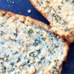 Parmesan cheese garlic bread already baked sitting on a table