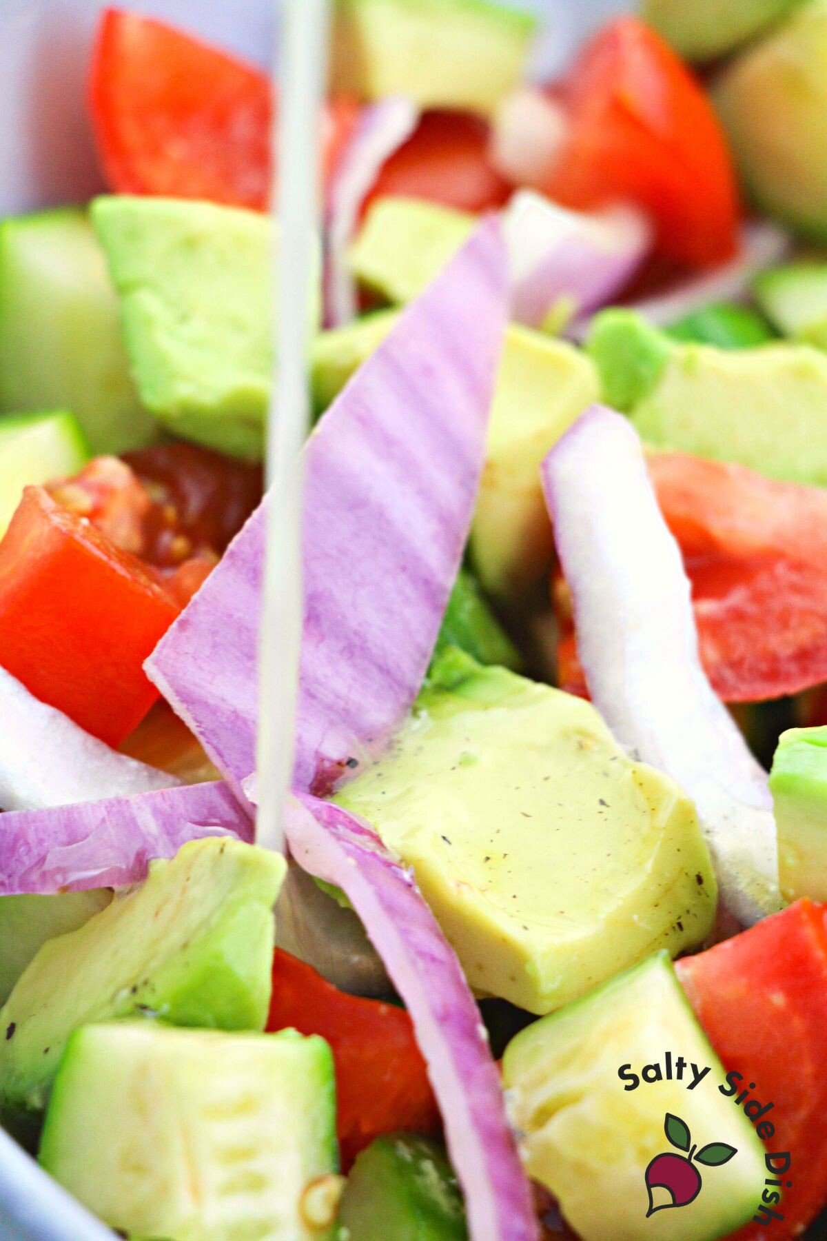 pouring dressing on salad.