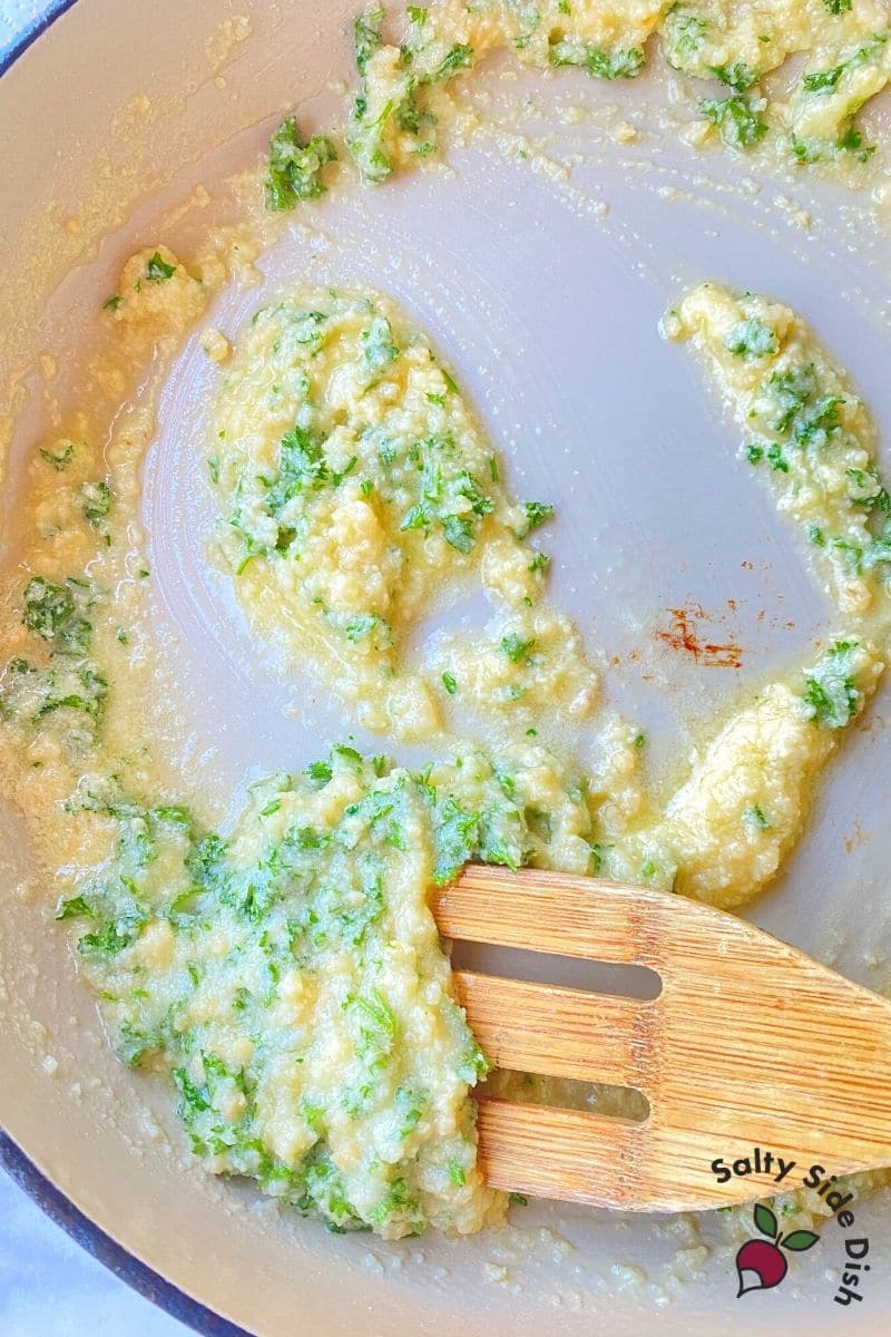 mixing together parmesan cheese, butter and herbs for Garlic Parmesan Bread