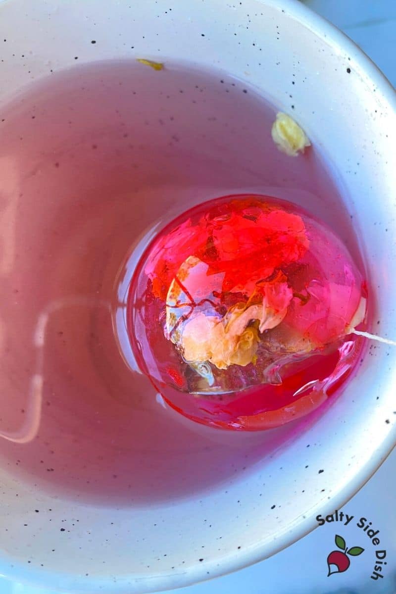 melted tea bomb in a glass of hot water