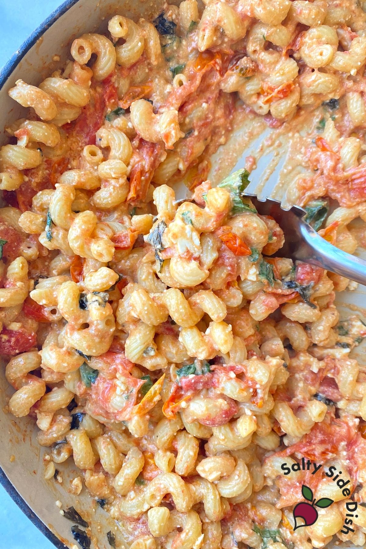 pasta mixed with feta, tomatoes, and basil