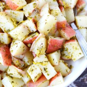close up of cut potatoes and herbs