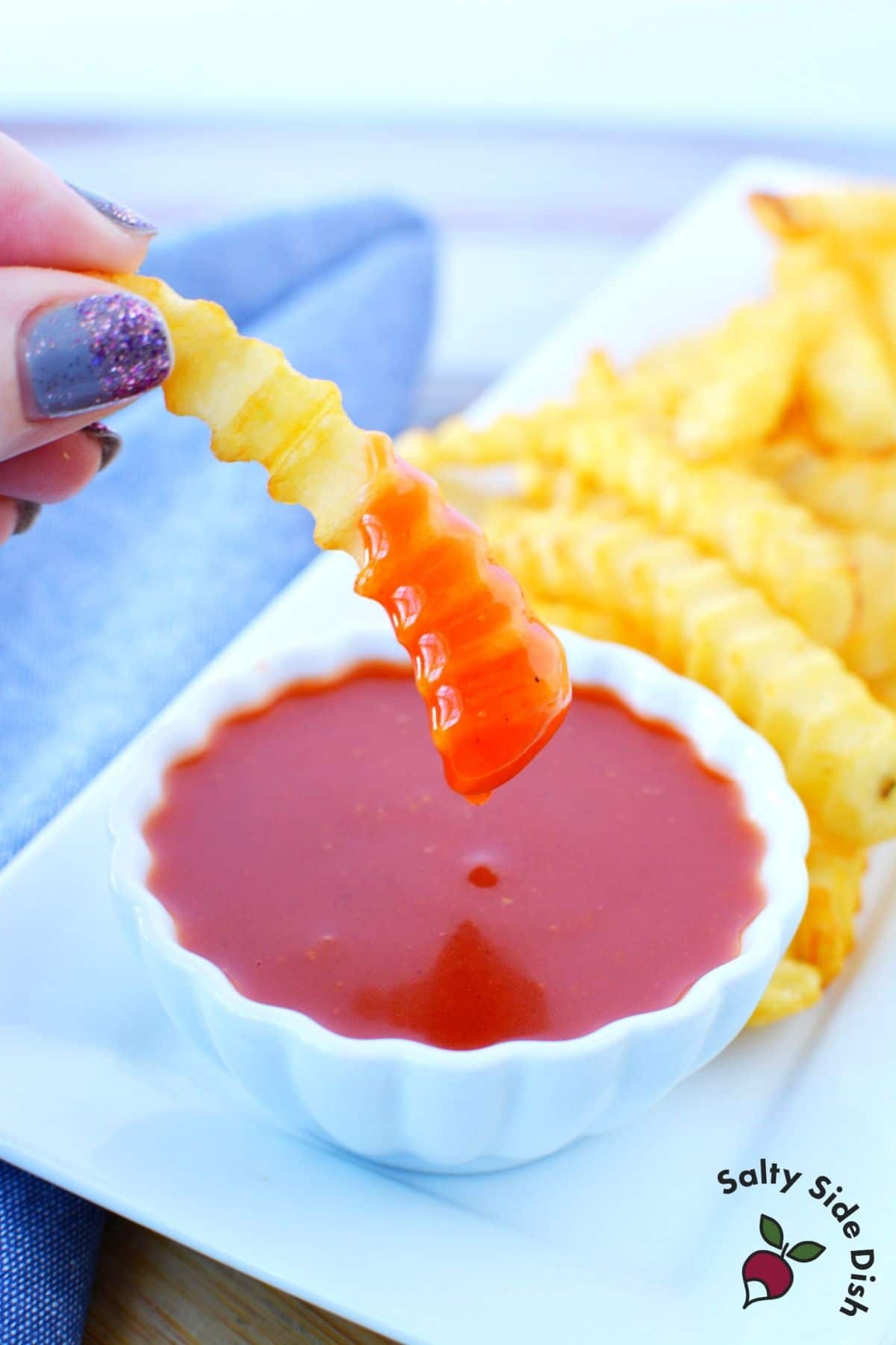 dipping fry into Polynesian sauce