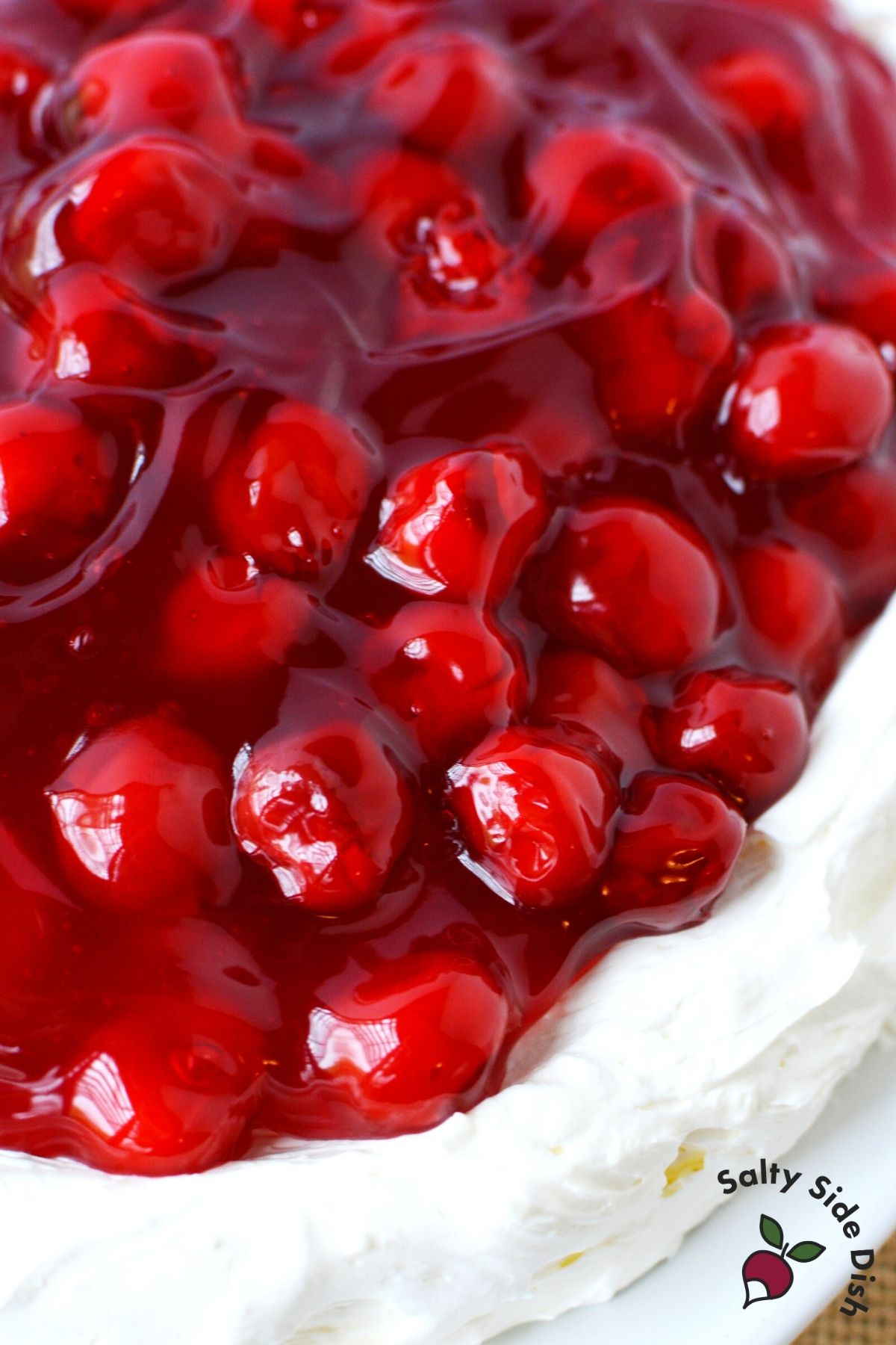 easy cherry cheesecake dip spread on a plate with cherry pie filling topping