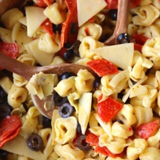 creamy tortellini salad in a wooden bowl