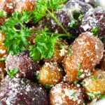 mini potatoes on a white plate with parsley