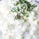 close up image of garlic dip with chives.