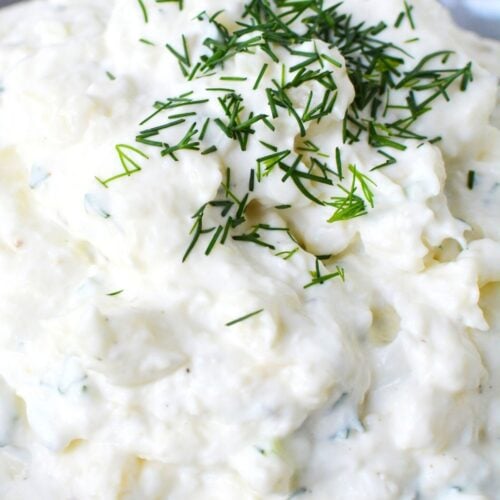 close up image of garlic dip with chives.