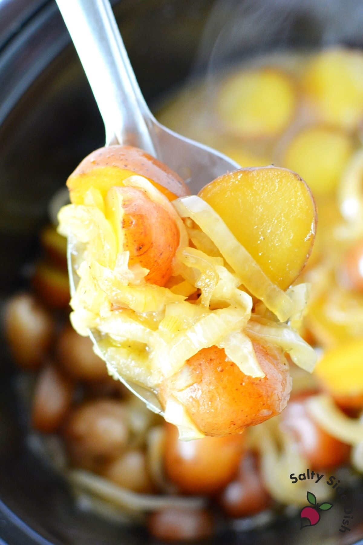 baby potatoes and onions on a spoon.