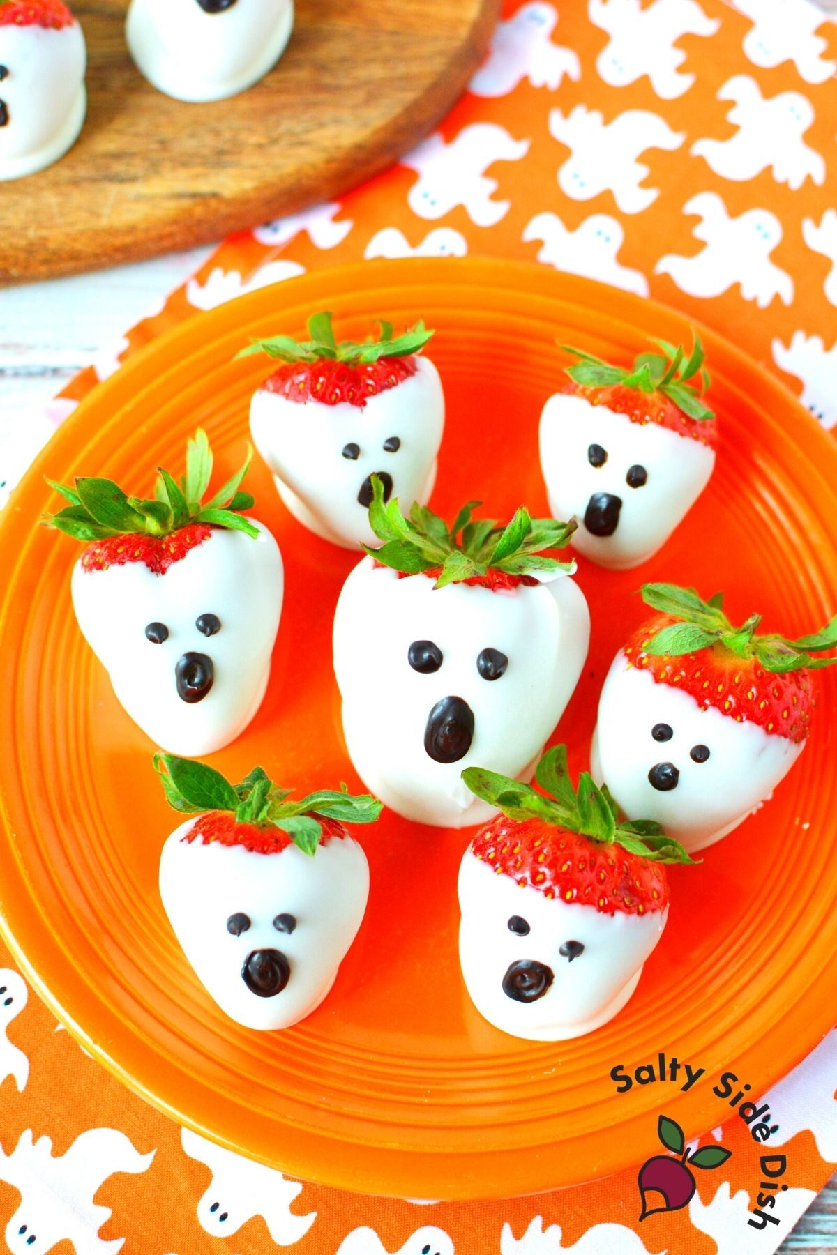 strawberry ghosts on an orange plate.