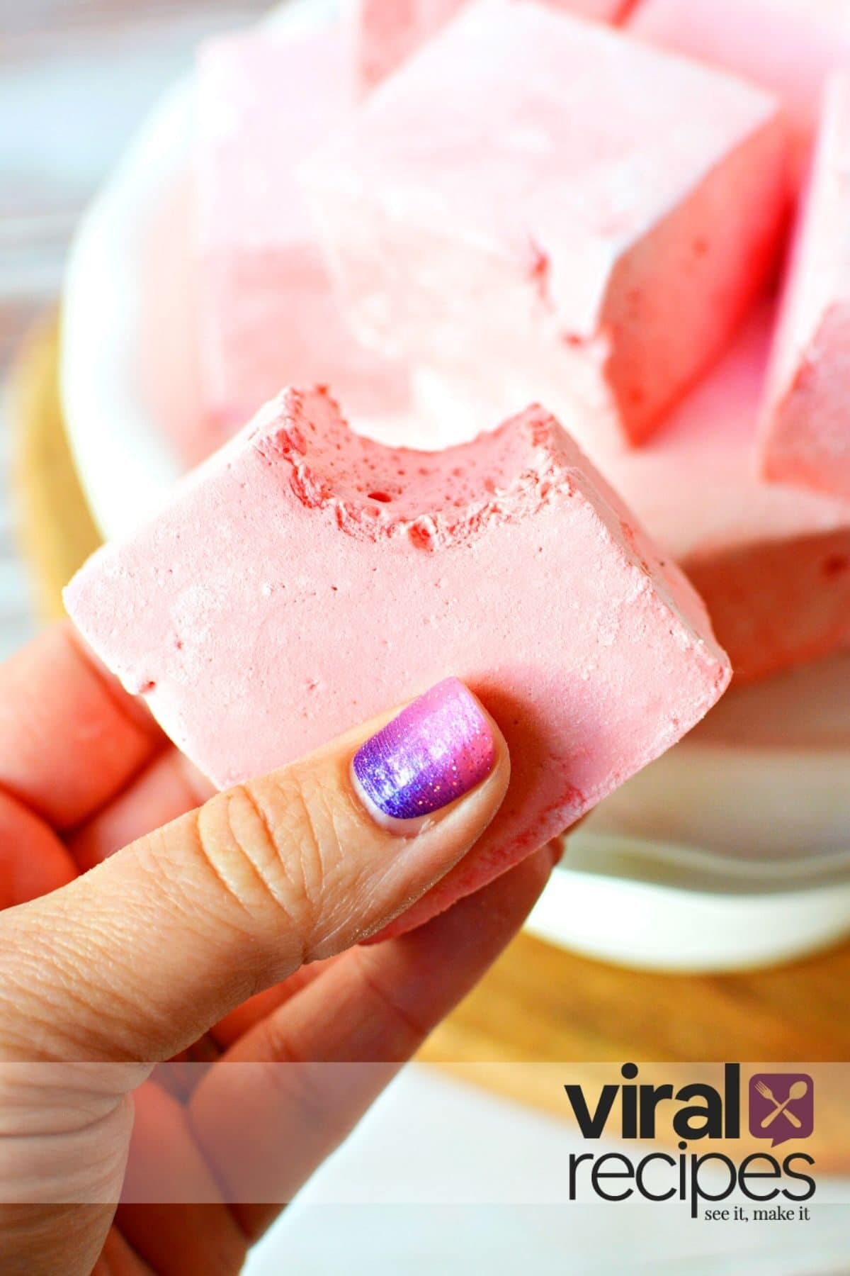 big bite out of a pink marshmallow.