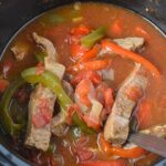 beef sirloin, bell peppers, and onions in a slow cooker.